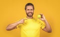 happy healthy man with vitamin fruit on background. healthy man with vitamin fruit in studio