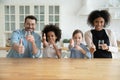 Happy healthy mixed race family recommending drinking water. Royalty Free Stock Photo