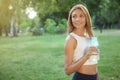 Gorgeous athletic woman drinking water at the park