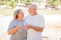 Happy Healthy Senior Couple Laughing with Water Bottles Outdoors Royalty Free Stock Photo