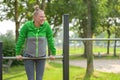 Happy healthy sporty middle-aged woman working out outdoors