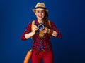 Happy healthy traveller woman with modern DSLR camera