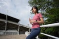 Happy healthy woman drinking water from bottle after workout exercise. Sports, nutrition bottle, and female athletes drink liquid Royalty Free Stock Photo