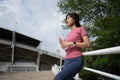 Happy healthy woman drinking water from bottle after workout exercise. Sports, nutrition bottle, and female athletes drink liquid Royalty Free Stock Photo