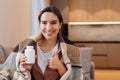 Happy healthy woman recommending omega 3 fish oil and holding out a pill in her hand Royalty Free Stock Photo