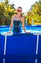 Happy healthy woman in swimming pool in sunglasses Royalty Free Stock Photo