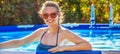 Happy healthy woman in swimming pool in sunglasses Royalty Free Stock Photo