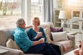 Happy hearts, happy home. a happy mature couple relaxing on the sofa and enjoying a coffee break together. Royalty Free Stock Photo