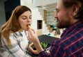 Happy heterosexual Caucasian couple in love enjoying cooking a healthy meal together in the kitchen island at home. Loving husband Royalty Free Stock Photo