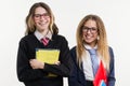 Happy high school friends closeup portrait. Pose on camera, in school uniform, with books and notebooks