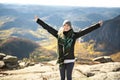 A Happy hiker with her arms outstretched, freedom and happiness, achievement in mountains Royalty Free Stock Photo