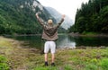 Happy hiker winning reaching life goal, success, freedom and happiness, achievement in mountains. Royalty Free Stock Photo