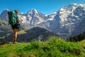 Happy hiker woman with backpack, enjoying the view, Murren, Switzerland