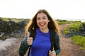 Happy hiking woman giving thumbs up smiling. Young hiker woman smiling joyful at camera outdoor on hike trip.