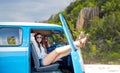 Happy hippie women in minivan car on island beach Royalty Free Stock Photo