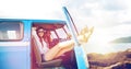 Happy hippie women in minivan car on summer beach Royalty Free Stock Photo