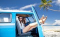 Happy hippie women in minivan car on summer beach Royalty Free Stock Photo