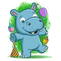 Happy hippopotamus celebrate the party with the balloon and cake