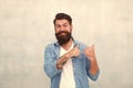 Happy hipster with beard pointing finger. barber care. mature bearded man. brutal hipster. happy mood. Male summer