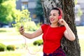 Happy hipster beautiful girl listening to music in the park Royalty Free Stock Photo