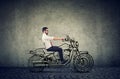 Happy hipster business man riding a motocycle Royalty Free Stock Photo