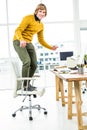 Happy hipster businessman standing on his chair