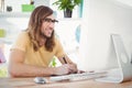 Happy hipster at computer desk Royalty Free Stock Photo