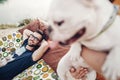 Happy hipster couple with bulldog relaxing in hammock on the beach in sunset light, summer vacation. stylish family with funny dog Royalty Free Stock Photo