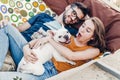 Happy hipster couple with bulldog relaxing in hammock on the beach in sunset light, summer vacation. stylish family with funny dog Royalty Free Stock Photo