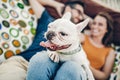 Happy hipster couple with bulldog relaxing in hammock on the beach in sunset light, summer vacation. stylish family with funny dog Royalty Free Stock Photo