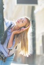 Happy hipster girl listening music on city street Royalty Free Stock Photo