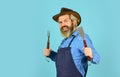 Happy hipster hold cooking utensils for barbecue. bearded man chef. Tools for roasting meat outdoors. Picnic and Royalty Free Stock Photo