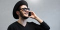 Happy hipster man with sunglasses caling on smartphone. Royalty Free Stock Photo
