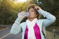 Happy hipster old women drinking water of bottle during backpack Royalty Free Stock Photo