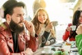 Happy hipster people drinking cappuccino and eating muffins - Young friends toasting coffee and doing breakfast in bar restaurant Royalty Free Stock Photo