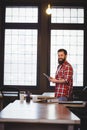 Happy hipster using tablet computer at desk Royalty Free Stock Photo