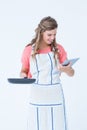 Happy hipster woman holding laptop and frying pan Royalty Free Stock Photo