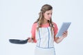 Happy hipster woman holding laptop and frying pan Royalty Free Stock Photo