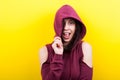 Happy hipster woman with a hood winking at the camera Royalty Free Stock Photo