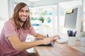 Happy hipster working on graphics tablet and computer Royalty Free Stock Photo