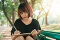 Happy hipster young asian woman writing into her diary in park. Happy hipster young asian woman working on notebook in park. Royalty Free Stock Photo