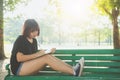 Happy hipster young asian woman writing into her diary in park. Royalty Free Stock Photo