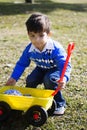 Happy hispanic boy playing with his toy truck Royalty Free Stock Photo