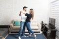 Happy Hispanic Couple Dancing At Home Royalty Free Stock Photo