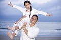 Happy Hispanic dad and girl having fun on beach Royalty Free Stock Photo