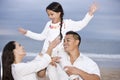 Happy Hispanic family and girl having fun on beach Royalty Free Stock Photo