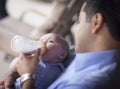 Happy Hispanic Father Bottle Feeding His Mixed Race Son