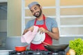 Happy hispanic kitchen assistant cleaning plates at work