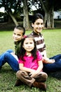 Happy hispanic siblings together in front of tree Royalty Free Stock Photo