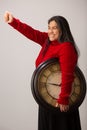 Happy Hispanic Woman With Clock Under Arm Lifts Fist Triumphantly